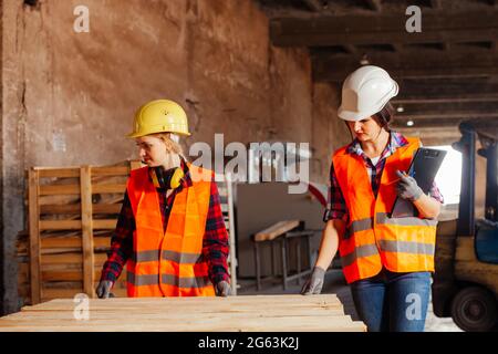 The young women in uniform working in a factory Stock Photo