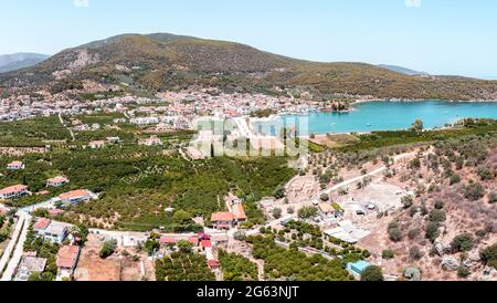 Greece, Ancient Epidaurus bay at Argolida. Aerial, drone view of traditional village and ancient theater, Peloponnese. Blue sky, calm sea, sunny day. Stock Photo