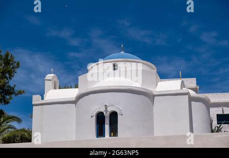 Church in a Greek island, Cyclades. Greece. Whitewashed walls and blue dome, white chapel against clear blue sky background. Christianity religion sum Stock Photo