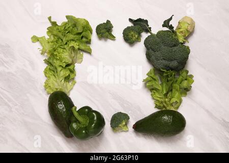 Green frame of vegetable on white marble. Stock Photo