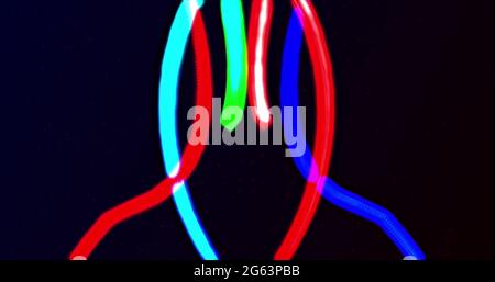 Two glowing red and blue neon lines entertwining on a black background Stock Photo