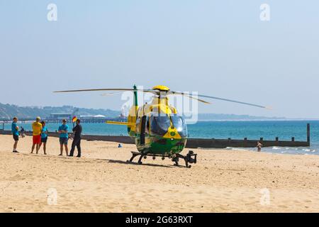 Bournemouth, Dorset UK. 2nd July 2021. Hampshire & Isle Of Wight Air Ambulance helicopter lands on Alum Chine beach, Bournemouth to attend a medical incident on the cliff top. Credit: Carolyn Jenkins/Alamy Live News Stock Photo