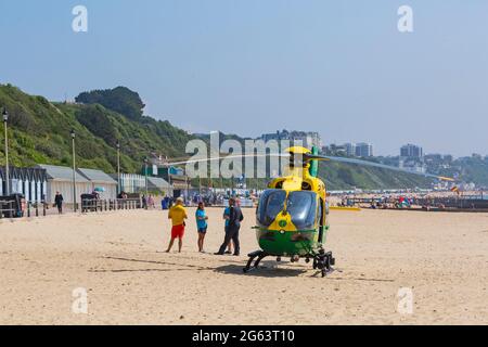 Bournemouth, Dorset UK. 2nd July 2021. Hampshire & Isle Of Wight Air Ambulance helicopter lands on Alum Chine beach, Bournemouth to attend a medical incident on the cliff top. Credit: Carolyn Jenkins/Alamy Live News Stock Photo