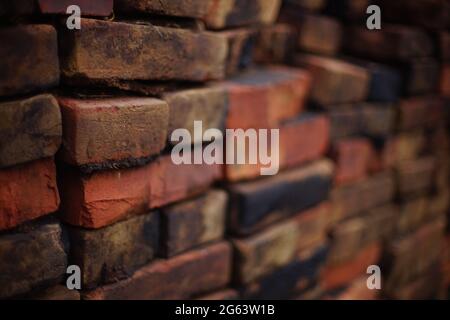stack of old red and black bricks. Stock Photo