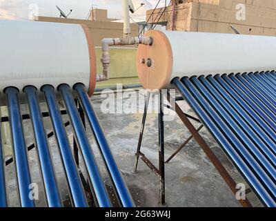 Solar panel tubes installed on roof tops to conserve energy and as alternative source of energy at Bengaluru India Stock Photo