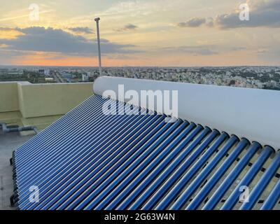 view of solar panel tubes installed on roof tops to conserve energy Stock Photo