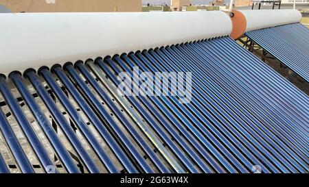 Solar panel tubes installed on roof tops to conserve energy and as alternative source of energy at Bengaluru India Stock Photo