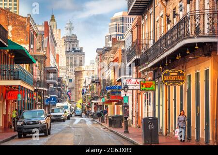 NEW ORLEANS, LOUISIANA - MAY 10, 2016: Traffic and pedestrians on Bourbon Street in the day. The historic street is the heart of the French Quarter. Stock Photo