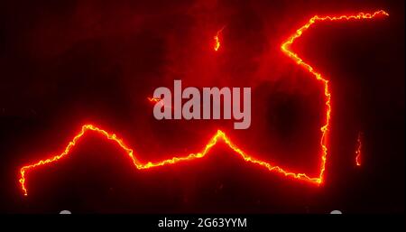 Glowing red and orange lightning bolts of electrical current and smoke moving wildly across a black Stock Photo