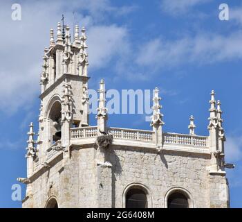 Upper part of the tower of the Cathedral of San Antolín in the city of Palencia, Spain. Gothic style and military use in the past. Sunny day. Stock Photo