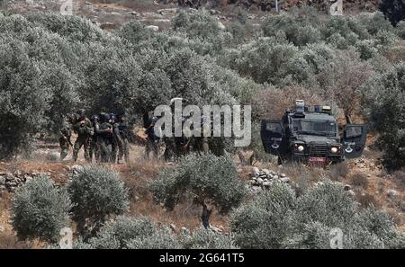 Nablus, West Bank city of Nablus. 2nd July, 2021. Israeli soldiers and members of Israeli border police are seen deployed during a protest against the expanding of Jewish settlements in the village of Beita, south of the West Bank city of Nablus, July 2, 2021. Credit: Nidal Eshtayeh/Xinhua/Alamy Live News Stock Photo