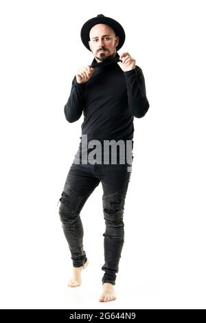 Young artist in black clothes wearing hat, turtleneck and jeans barefoot posing. Full body portrait isolated on white background Stock Photo