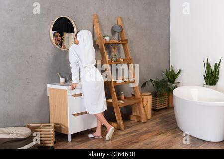 Beautiful White Bathroom Wooden Shelves Rolled Towels Stacked