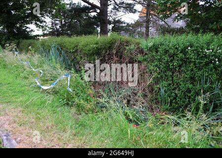 June 2021 - Police tape at a car crash accident site on rural lane in