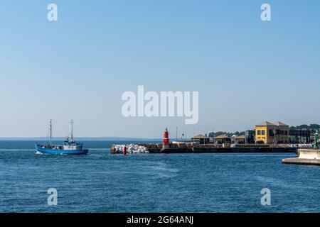 Helsingor, Denmark - 17 June 2021: fishing boat leaves the harbor of Helsingor Stock Photo