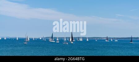 Helsingor, Denmark - 17 June 2021: panorama view of many sailboats sailing on a calm blue ocean Stock Photo