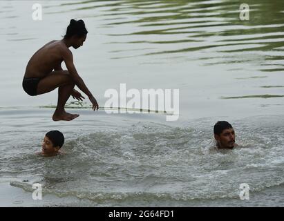 New Delhi, India. 02nd July, 2021. People jump into a canal to get some respite from scorching heat on a hot summer day in the Indian capital of New Delhi on Friday, July 2, 2021. Many parts of the country are reeling under severe heat wave. Photo by Abhishek/UPI Credit: UPI/Alamy Live News Stock Photo