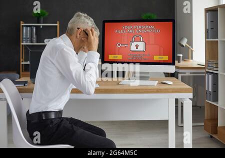 Man's computer has been hacked by ransomware virus and now he has to pay extortion Stock Photo