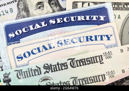Macro view of Social Security cards, United States Treasury checks and cash. Stock Photo