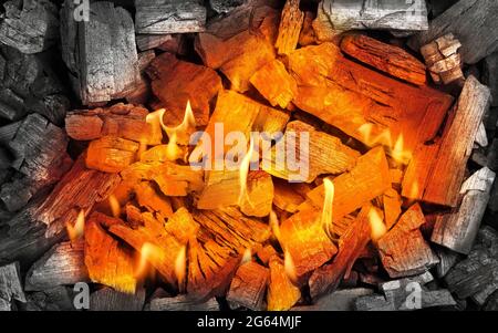 Close up red hot aglow coals in charcoal grill with fire flames and sparks, high angle view, directly above Stock Photo