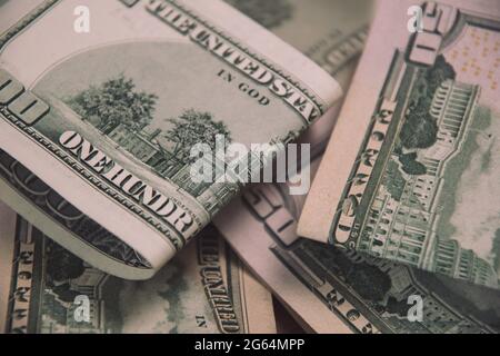 Financial background of US dollar paper cash banknotes folded in halves. Closeup fifty dollar and one hundred dollar bills Stock Photo