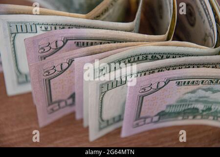 Bundle of one hundred dollar bills and fifty dollar bills closeup. Cash money banknotes top view Stock Photo