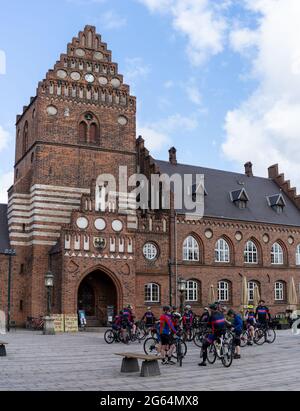 'Roskilde, Denmark . 13 June, 2021: large group of cyclists from a club meet on the town square of Roskildde for a weekend bicycle tripRoskilde, Denma Stock Photo