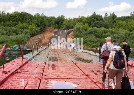 BELARUS, NOVOPOLOTSK - 02 JULE, 2021: People walk on the unfolded pontoon bridge in summer Stock Photo