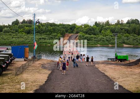 BELARUS, NOVOPOLOTSK - 02 JULE, 2021: People walk on the unfolded pontoon bridge in summer Stock Photo