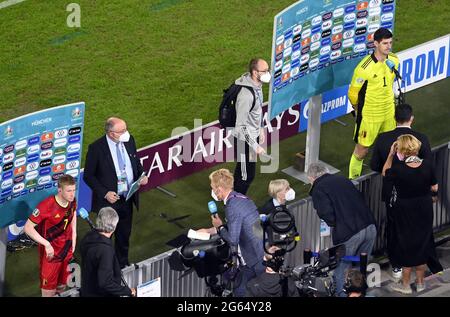 Belgium's Kevin De Bruyne and Belgium's goalkeeper Thibaut Courtois talk to the press after the quarter-finals game of the Euro 2020 European Champion Stock Photo