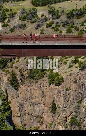 People on bridge crossing Sunlight Creek along Chief Joseph Scenic Byway, Shoshone National Forest, Wyoming, USA [No model releases; editorial licensi