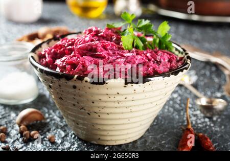 Salad of boiled beet. Beetroot salad with walnuts, eggs and sour cream in a bowl. Healthy food. Stock Photo