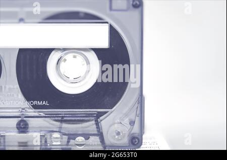 Transparent 90 minute audio cassette with blank adhesive label. Side A of the cassette. Magnetic tape and audio reproduction from the 70s and 80s. Ret Stock Photo