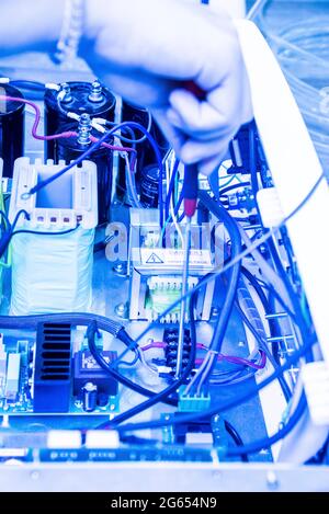 Technician fixing an electronic device Stock Photo
