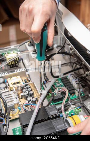Technician fixing an electronic device Stock Photo