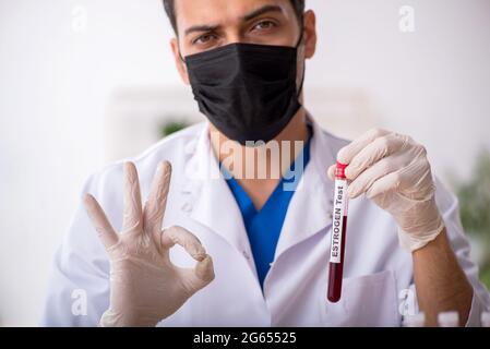Young biochemist testing blood samples Stock Photo