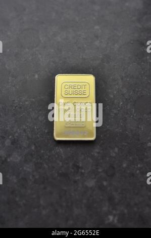 1 ounce of gold bar on bench Stock Photo