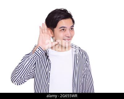 young handsome man  smiling and making listening gestures.Isolated on white background. Stock Photo