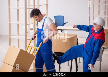 Two professional movers doing home relocation Stock Photo