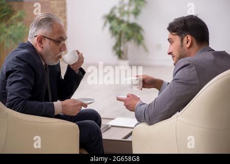 Two businessmen discussing project in the office Stock Photo
