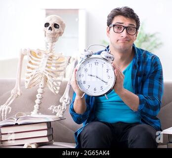 The student studying with skeleton preparing for exams Stock Photo