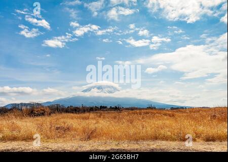 Beautiful landscape with Mount Fuji with snow and hat shaped cloud. Horizontal shot. Photo taken from National Route 139 in Yamanashi Ken, Japan. Stock Photo