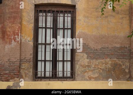 Old window with iron bars. Stock Photo