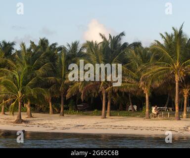 A man rides a bike along the beach. Stock Photo