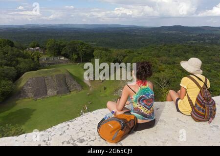 Two tourists view the ruins at Xunantunich from atop 'El Castillo.' Stock Photo