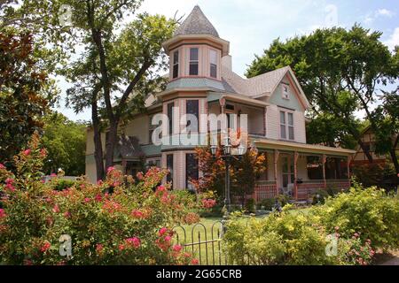 Victorian House with fence and plants Stock Photo