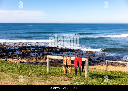 Surfers in winter wetsuits on quiet out-of-season Newgale Beach along ...