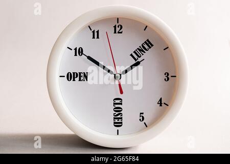 Sign design for a shop or office, opening and closing times in the form of a wall clock. Stock Photo