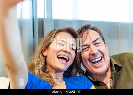 Smiling mature man and woman taking a selfie. Stock Photo