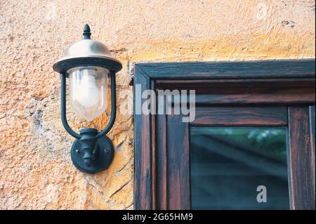 Rustic wall with lamp and part of window Stock Photo